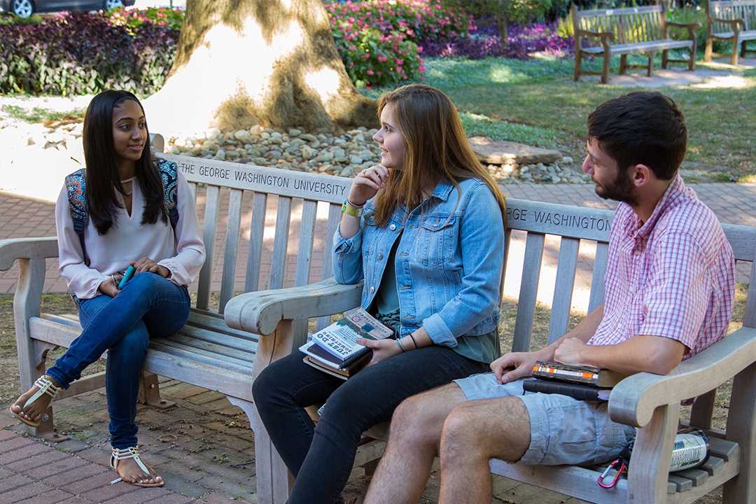 A group of GW students talking in university yard
