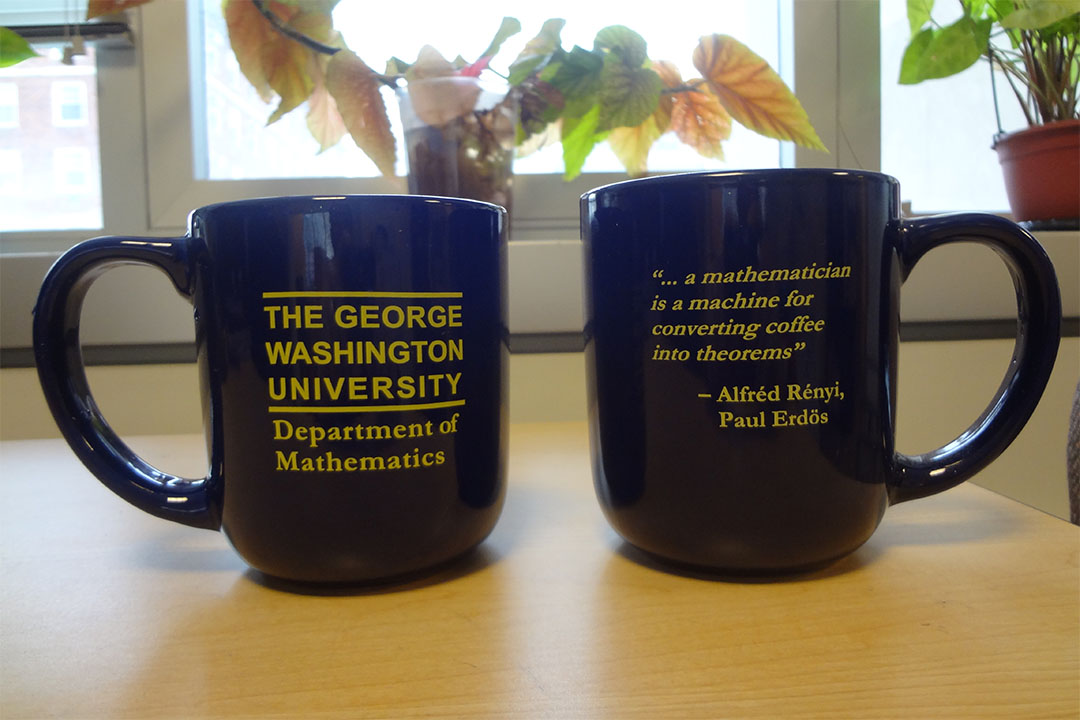 Two blue mugs with the Math Department logo