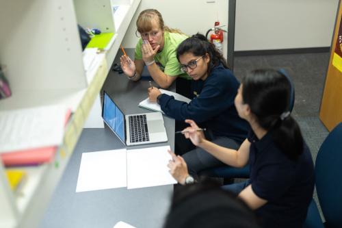 3 students discussing in a math session