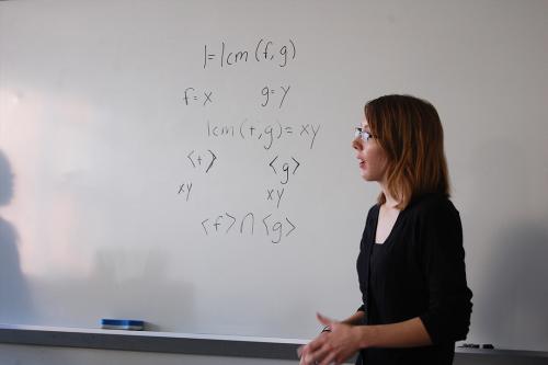 A Woman in Math student explaining a formula